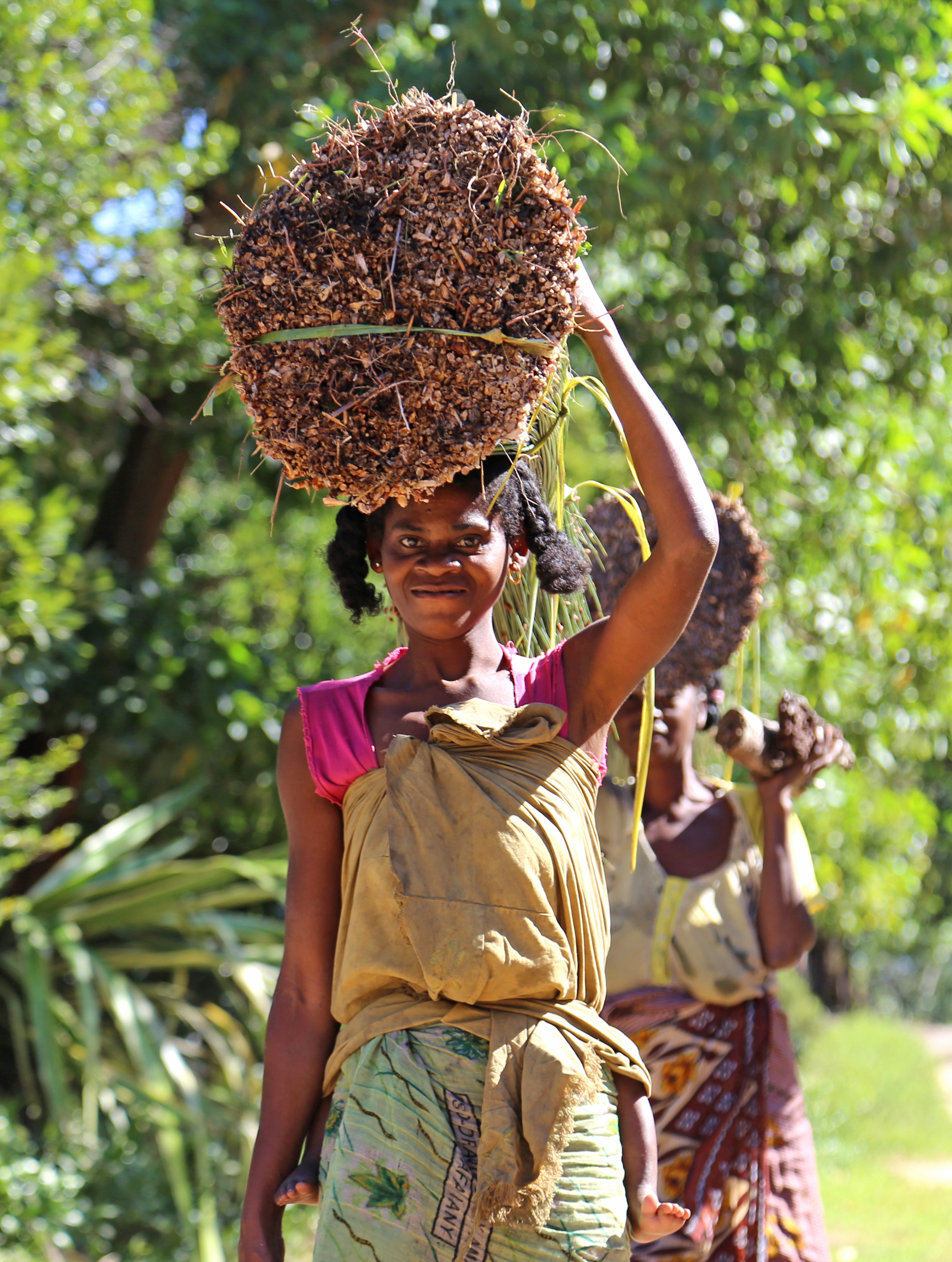Woman carrying mahampy and baby